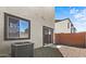 Backyard with gravel and partial concrete, sliding glass door and brick fence at 7446 S 75Th Dr, Laveen, AZ 85339
