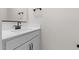 Bathroom showcasing a white vanity with black fixtures, a large mirror, and clean, modern design at 7446 S 75Th Dr, Laveen, AZ 85339