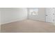 Bedroom featuring neutral carpet, natural light from a window, and an open doorway to additional rooms at 7446 S 75Th Dr, Laveen, AZ 85339