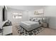 Bright bedroom featuring plush carpeting, a decorative rug and a modern platform bed at 7446 S 75Th Dr, Laveen, AZ 85339