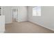 Bedroom with neutral carpet, natural light from a window, and an open doorway to additional rooms at 7446 S 75Th Dr, Laveen, AZ 85339