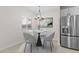 Dining area with modern chandelier and stainless steel refrigerator at 7446 S 75Th Dr, Laveen, AZ 85339