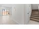 Open entryway featuring tile flooring, a staircase with carpet, and a sliding glass door to the outdoor space at 7446 S 75Th Dr, Laveen, AZ 85339