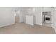 Upstairs hallway featuring a laundry area with a modern washer and dryer, and an open doorway at 7446 S 75Th Dr, Laveen, AZ 85339