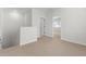 Hallway featuring neutral carpet, an open doorway, and natural light from a window in the adjacent room at 7446 S 75Th Dr, Laveen, AZ 85339