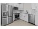 Kitchen featuring white cabinets, subway tile backsplash, and stainless steel appliances at 7446 S 75Th Dr, Laveen, AZ 85339