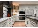 Modern kitchen featuring custom cabinets, stainless steel appliances, and marble countertops at 8541 N Farview Dr, Scottsdale, AZ 85258