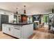 Open-concept kitchen island, stainless appliances, and seamless flow to the living room at 8541 N Farview Dr, Scottsdale, AZ 85258