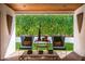 Inviting covered patio with comfortable seating and views of the lush, green backyard at 8541 N Farview Dr, Scottsdale, AZ 85258