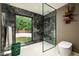 Contemporary shower with sleek glass enclosure, marble tile, and a view to the private yard at 8541 N Farview Dr, Scottsdale, AZ 85258