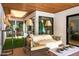 Bright sun room with beamed wood ceiling, a comfortable sofa, skylight and multiple windows at 8541 N Farview Dr, Scottsdale, AZ 85258