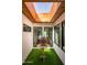 Bright sunroom with a skylight, artificial turf, and an antique urn on a decorative table at 8541 N Farview Dr, Scottsdale, AZ 85258