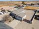 Expansive aerial view of desert home with a low profile, neutral palette, gravel yard, and convenient garage access at 918 E Lincolnwood Cir, Casa Grande, AZ 85194