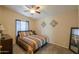 This bedroom features a ceiling fan, carpet flooring, and a large mirror at 918 E Lincolnwood Cir, Casa Grande, AZ 85194