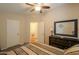 Bright bedroom with a ceiling fan, dresser, and carpet flooring at 918 E Lincolnwood Cir, Casa Grande, AZ 85194