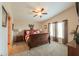 Comfortable main bedroom with a king-size bed, ceiling fan, and neutral decor at 918 E Lincolnwood Cir, Casa Grande, AZ 85194