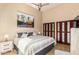 Vaulted ceiling bedroom featuring a ceiling fan, large wall art, and closet with folding doors at 10015 E Mountain View Rd # 2017, Scottsdale, AZ 85258