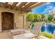 Tranquil poolside lounge area with shade, seating, and views of a beautiful water feature at 10015 E Mountain View Rd # 2017, Scottsdale, AZ 85258