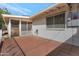 Back patio featuring brick pavers, white brick wall and screened in porch on a sunny day at 10408 N 105Th Ave, Sun City, AZ 85351