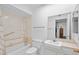 Bathroom featuring a tub with shower, white toilet, and a sink with cream-colored countertop at 10408 N 105Th Ave, Sun City, AZ 85351