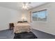 Serene bedroom with brick wall and a ceiling fan providing natural light from a sunlit window at 10408 N 105Th Ave, Sun City, AZ 85351