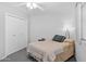 Bedroom featuring white walls, carpeted floors, double door closet and ceiling fan at 10408 N 105Th Ave, Sun City, AZ 85351