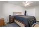 Bedroom featuring a bed with headboard, ceiling fan, closet, and natural light from the window at 10408 N 105Th Ave, Sun City, AZ 85351