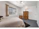 Bright bedroom with a ceiling fan featuring an armoire and a window providing natural light at 10408 N 105Th Ave, Sun City, AZ 85351