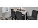 Bright dining area featuring a modern table, four chairs, and stylish decor at 10408 N 105Th Ave, Sun City, AZ 85351