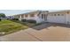 Lovely single-story home with garage and a charming American flag displayed near the front door at 10408 N 105Th Ave, Sun City, AZ 85351