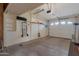 Attached garage with an automatic garage door and open shelving, offering ample parking and storage at 10408 N 105Th Ave, Sun City, AZ 85351