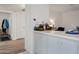 Bright hallway showcases white cabinets and access to other living spaces in the home at 10408 N 105Th Ave, Sun City, AZ 85351