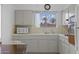 Kitchen includes updated microwave, matching cabinetry, and sunny window at 10408 N 105Th Ave, Sun City, AZ 85351