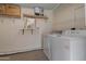Functional laundry area equipped with a washer, dryer, and practical shelving for storage solutions at 10408 N 105Th Ave, Sun City, AZ 85351