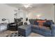 Bright living room features a comfortable gray sofa and views to the kitchen at 10408 N 105Th Ave, Sun City, AZ 85351
