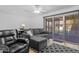 Cozy living room with a ceiling fan, comfortable seating, and sliding glass doors at 10408 N 105Th Ave, Sun City, AZ 85351
