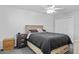 Main bedroom features neutral walls, ceiling fan and wood-look furnishings at 10408 N 105Th Ave, Sun City, AZ 85351