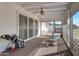Enclosed patio with white brick, ceiling fan, and screened windows, ideal for relaxation and outdoor dining at 10408 N 105Th Ave, Sun City, AZ 85351