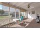 Enclosed patio area with white brick, screened windows, and comfortable seating arrangement for outdoor enjoyment at 10408 N 105Th Ave, Sun City, AZ 85351