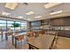 A community activity room includes tables, chairs, cabinets, and natural light at 10726 E Tallahassee Ave, Mesa, AZ 85212