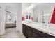 Bathroom featuring a double sink vanity with sleek fixtures and a view into bedroom at 10726 E Tallahassee Ave, Mesa, AZ 85212