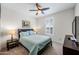 Cozy bedroom with a plush bed, neutral carpet, and a ceiling fan for optimal comfort at 10726 E Tallahassee Ave, Mesa, AZ 85212