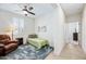 Cozy bedroom offers a ceiling fan, ample natural light, and an open doorway to the adjacent hallway at 10726 E Tallahassee Ave, Mesa, AZ 85212