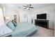 Spacious bedroom featuring a comfortable bed, large dresser, and a ceiling fan for optimal comfort at 10726 E Tallahassee Ave, Mesa, AZ 85212