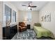 Bright bedroom featuring a single bed, plush rug, ceiling fan, and shuttered window for a cozy and inviting space at 10726 E Tallahassee Ave, Mesa, AZ 85212