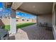 Backyard covered patio featuring a beautiful exterior lawn and ample space for outdoor seating and entertainment at 10726 E Tallahassee Ave, Mesa, AZ 85212