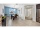Stylish dining area with a view of the entryway and stainless steel appliances in the kitchen at 10726 E Tallahassee Ave, Mesa, AZ 85212
