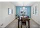 Bright dining room featuring a modern light fixture and a view of the neighborhood through the window at 10726 E Tallahassee Ave, Mesa, AZ 85212