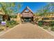 A community entrance boasts modern architecture, landscaping, and a welcoming walkway at 10726 E Tallahassee Ave, Mesa, AZ 85212