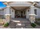 Inviting front porch with stone accents, cozy seating, and a welcoming entrance at 10726 E Tallahassee Ave, Mesa, AZ 85212